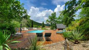 a deck with chairs and a swimming pool at The Bergerie in Roquetaillade