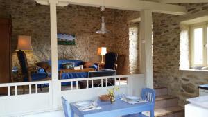 a dining room with blue chairs and a table at The Bergerie in Roquetaillade