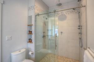 a bathroom with a glass shower with a toilet at Bright, Contemporary, Walk To Town & Beach in Eastsound +22 photos