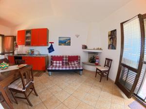 a kitchen with red cabinets and a table and chairs at Villa Grazia in Santa Lucia +16 photos