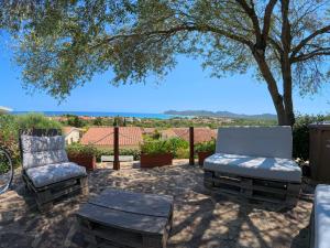 a patio with two chairs and a table and a tree at Villa Grazia in Santa Lucia