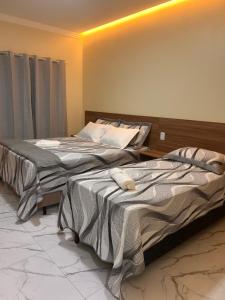 two beds sitting next to each other in a room at Pousada Luz do El Shaday in Barreirinhas +37 photos