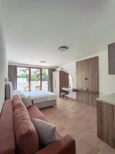a living room with a couch and a bed at Guesthouse Nesa in Ulcinj