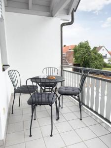 a patio with two chairs and a table on a balcony at Ruster Drachennest - Europa Park by living TIMELESS in Rust