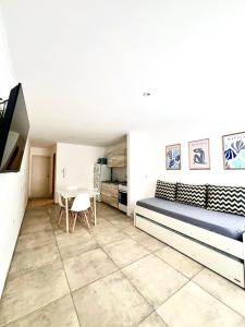 a living room with a bed and a table at FINCA NOVA Apartment 7 in Balcarce