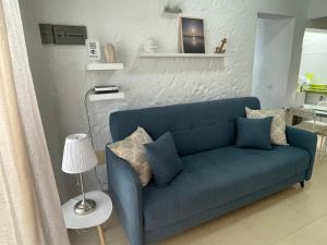 a blue couch in a living room with a lamp at Tartanas Granca in Playa del Ingles