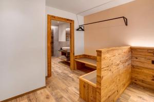 a dressing room with a mirror and a bench at Borch Chalet Livigno in Livigno +53 photos