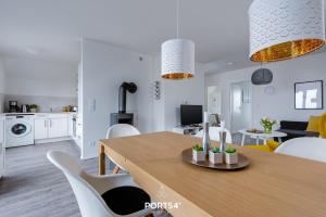 a kitchen and living room with a table and chairs at Hoppetosse in Olpenitz