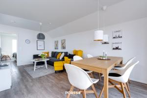 a living room with a table and a couch at Hoppetosse in Olpenitz