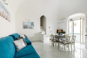 a living room with a blue couch and a table at APARTAMENT OLIWIA - Julia Vieste in Vieste