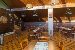 una sala da pranzo con tavoli e sedie in legno di Brunarica Bled Zatrnik Pokljuka a Bled Altre 60 foto