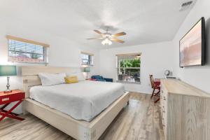 a bedroom with a bed and a ceiling fan at 306 Jack Drive in Cocoa Beach +33 photos