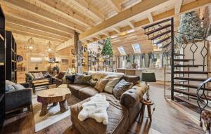 a living room with a couch and a spiral staircase at Hunting Lodge in Detern