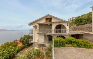 a house on a hill next to the water at Gorgeous Apartment In Sveti Juraj With Wifi in Sveti Juraj