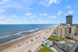 a view of the beach from the balcony of a resort at Beachfront 3 Bed, 3 Bath Condo, Balcony & Pool in Daytona Beach Shores