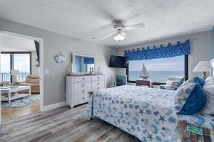 a bedroom with a bed and a view of the ocean at Beachfront 3 Bed, 3 Bath Condo, Balcony & Pool in Daytona Beach Shores