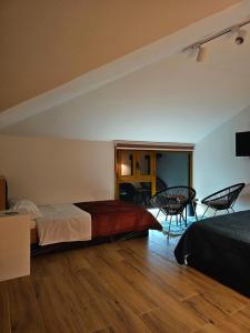 a bedroom with two beds and a table and chairs at Lemon Garden in Gjirokastër