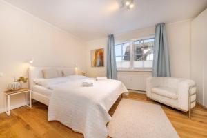 Ένα ή περισσότερα κρεβάτια σε δωμάτιο στο Villa Vilmblick Ferienwohnung Hafenglück