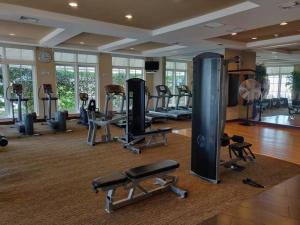 a gym with several treadmills and machines in a room at Apartment In Casa Costa Condo!beach Pass Included in Boynton Beach