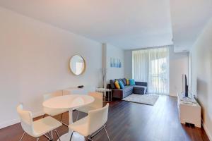 a living room with a table and a couch at Apartment In Casa Costa Condo!beach Pass Included in Boynton Beach