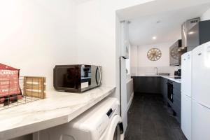 a kitchen with a sink and a microwave at 4 BEDS, 4 BATHS home, central Darlington in Darlington