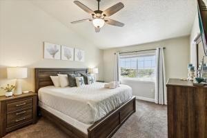 a bedroom with a bed and a ceiling fan at Cape Crossing 103 in Merritt Island +76 photos