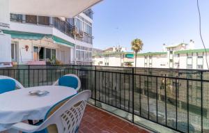 a patio with a table and chairs on a balcony at 1 Bedroom Cozy Apartment In Torremolinos in Torremolinos +24 photos
