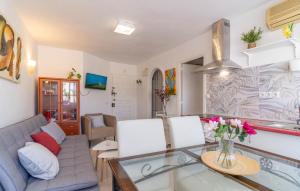 a living room with a couch and a glass table at 1 Bedroom Cozy Apartment In Torremolinos in Torremolinos