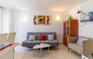 a living room with a couch and a chair at 1 Bedroom Cozy Apartment In Torremolinos in Torremolinos