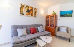 a living room with a couch and a chair at 1 Bedroom Cozy Apartment In Torremolinos in Torremolinos