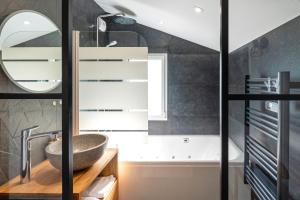 a bathroom with a sink and a mirror at Maison de vacances Des Tucs Dou in Seignosse +23 photos