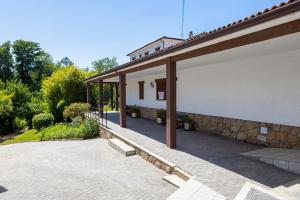 a patio of a house with a stone wall at Hotel Rural Venero Claro by Kerbest in Navaluenga +44 photos
