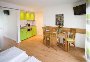 a kitchen and dining room with a table and chairs at Ruster Drachennest - Europa Park by living TIMELESS in Rust