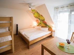 a bedroom with a bed with a dinosaur on the wall at Ruster Drachennest - Europa Park by living TIMELESS in Rust