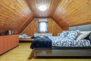 a bedroom with a bed and a wooden ceiling at Rural Holiday House Monto in Gladovec Pokupski +86 photos