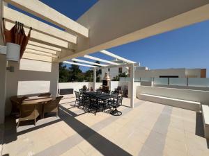 a patio with a table and chairs on a balcony at Luxury Penthouse for lifelong memories in Marbella