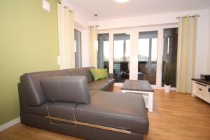 a living room with a couch and a table at Wohnen am Yachthafen W45 in Cuxhaven