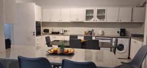 a kitchen with a table and chairs in a kitchen at Ermioni's House in Ktima