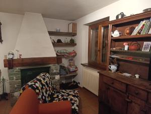 a living room with a chair and a fireplace at Da Gigi e Laura in Cogne