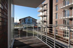 an open balcony with a view of a building at Wohnen am Yachthafen W46 in Cuxhaven