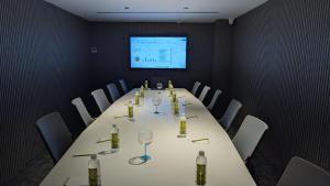 a conference room with a long table with wine glasses at Fressotel, Kanakapura Road in Bengaluru +14 photos