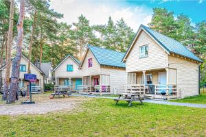a group of houses with picnic tables in front of them at Kolorowe Domki in Pobierowo