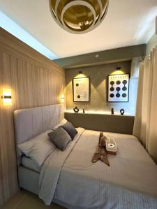 a bedroom with a large bed with a large white bedspread at Philhaus Staycation 2025 in Manila