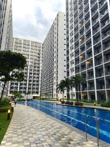 a swimming pool in front of two tall buildings at Philhaus Staycation 2025 in Manila +13 photos