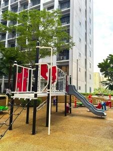 a playground with a slide in a park at Philhaus Staycation 2025 in Manila