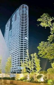 a tall white building with trees in front of it at CASA UMBER - JTOWER behind SM JMALL in Mandaue City +11 photos