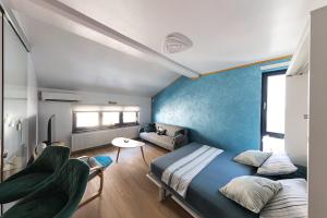 a bedroom with two beds and a blue wall at Lacul Morii Cozy Stay in Bucharest