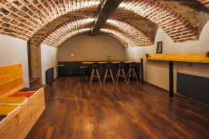a large room with a bar with stools in it at Gîte La Grenadine in Saint-Firmin