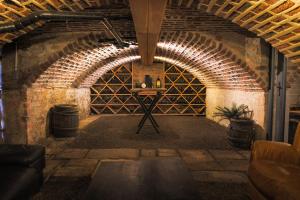 an empty wine cellar with a table in a room at Gîte La Grenadine in Saint-Firmin