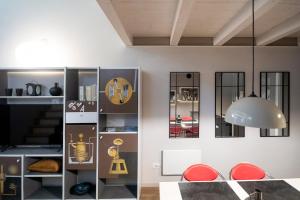 a living room with a clock on the wall at Casa degli Specchi- Duplex in city center in Arona